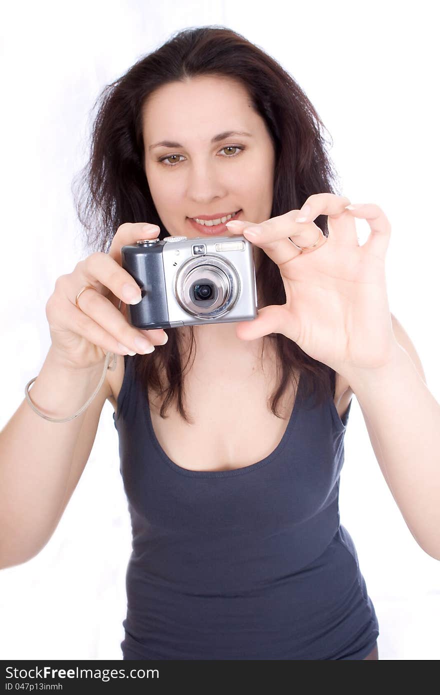 Woman with a camera takes on a white background