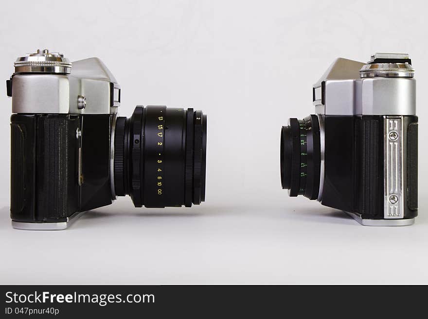 Two old SLR cameras on grey background