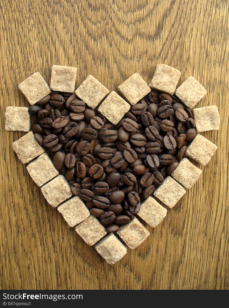 Heart shape Coffee Beans on wooden background ( close up )