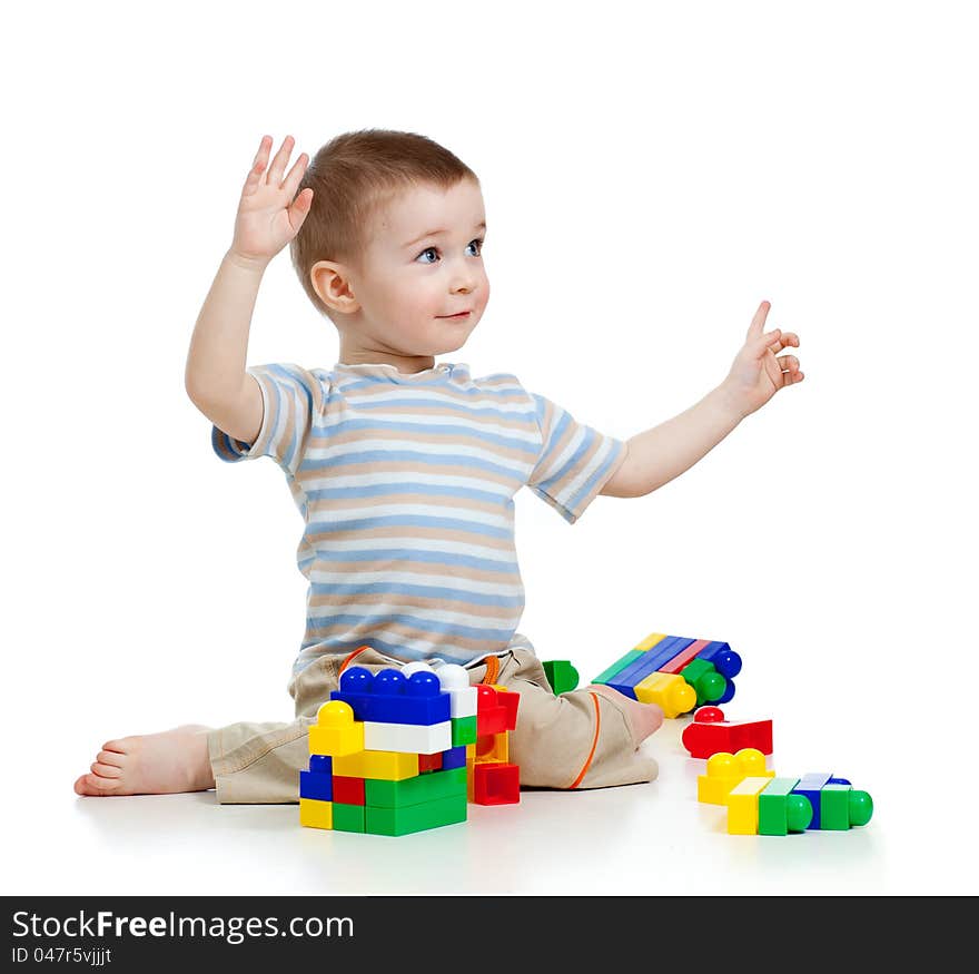 Little cheerful child with construction set over white background