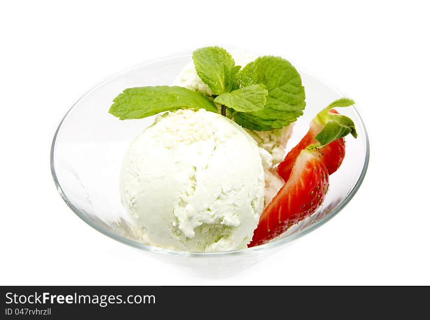 Ice cream with strawberries in a glass beaker decorated with mint