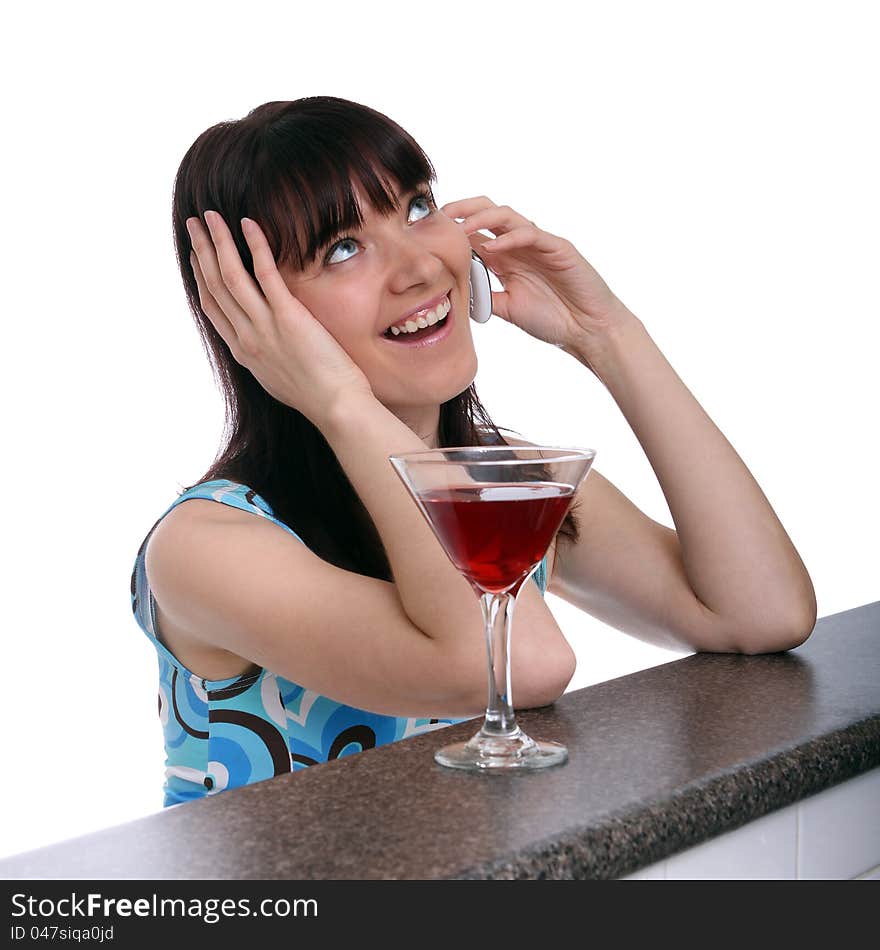 Woman having a drink and talking on the phone