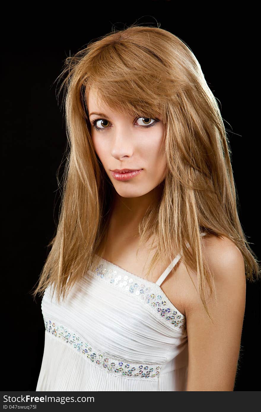 The portrait of the yoing girl on the black background. The portrait of the yoing girl on the black background