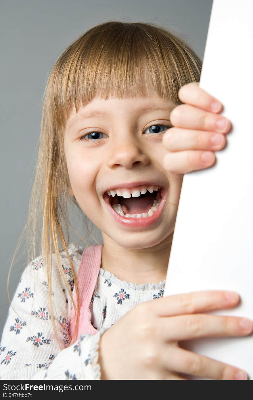 A studio portrait of a girl laughing