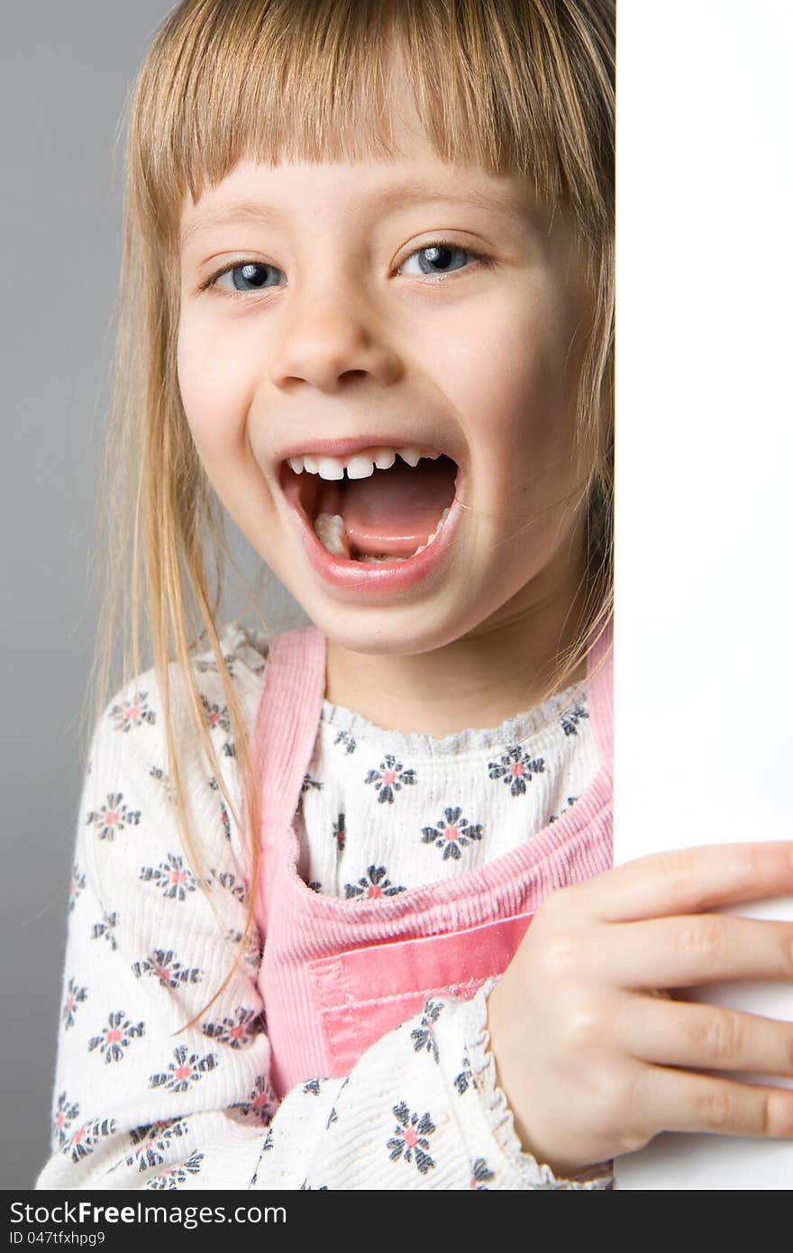 A studio portrait of a girl laughing