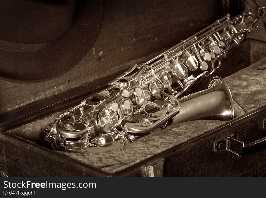 Man's Hat and saxophone in an old suitcase