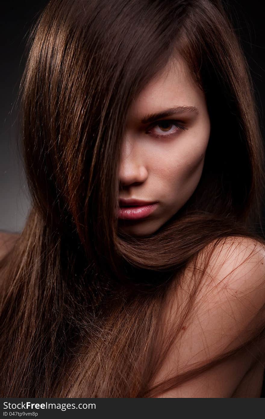 Studio portrait of attractive young woman with long hair. Studio portrait of attractive young woman with long hair