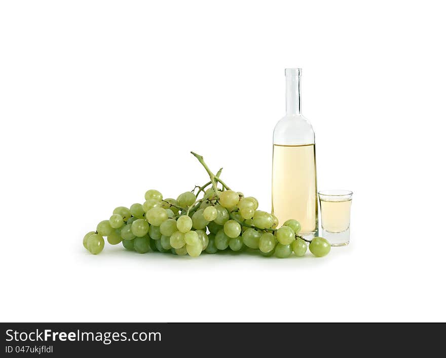 Open bottle of Italian vodka �grappa� near wineglass and bunch of grapes on white background. Clipping path is included. Open bottle of Italian vodka �grappa� near wineglass and bunch of grapes on white background. Clipping path is included