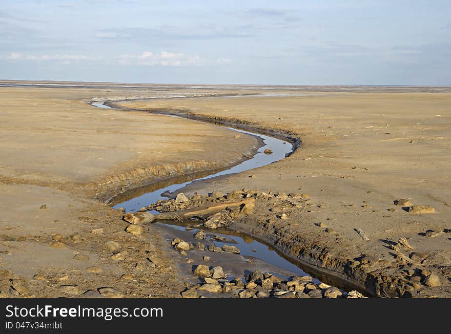 Brook in a deserted land near salty lake Baskunchak