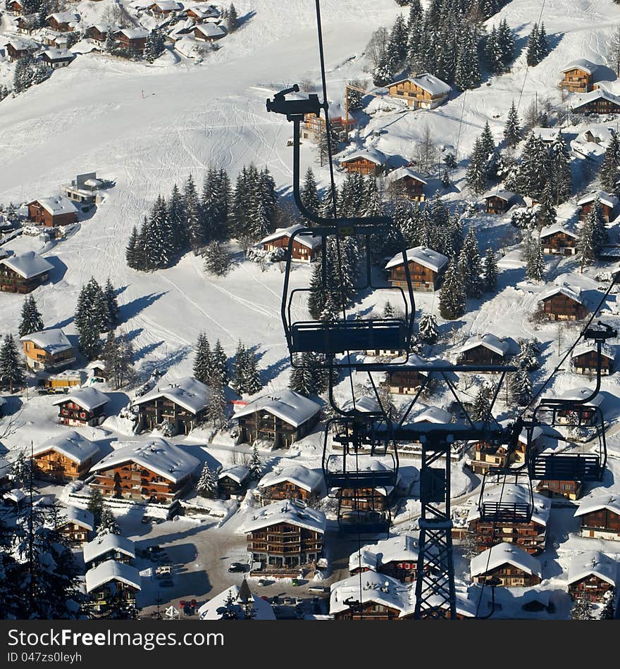 Chair lift going up over the ski village of Morgins. Chair lift going up over the ski village of Morgins