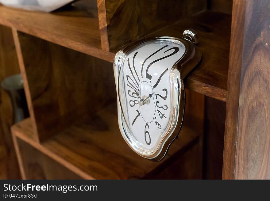 Photo creative decorative clock on a wooden shelf. Photo creative decorative clock on a wooden shelf