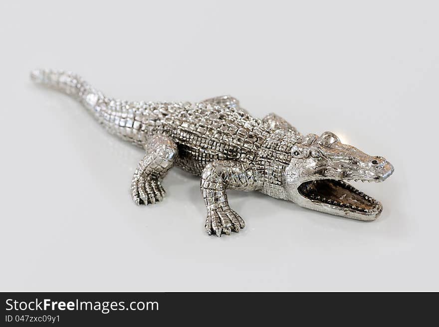 Photos of decorative figurines crocodile on a light background. Photos of decorative figurines crocodile on a light background