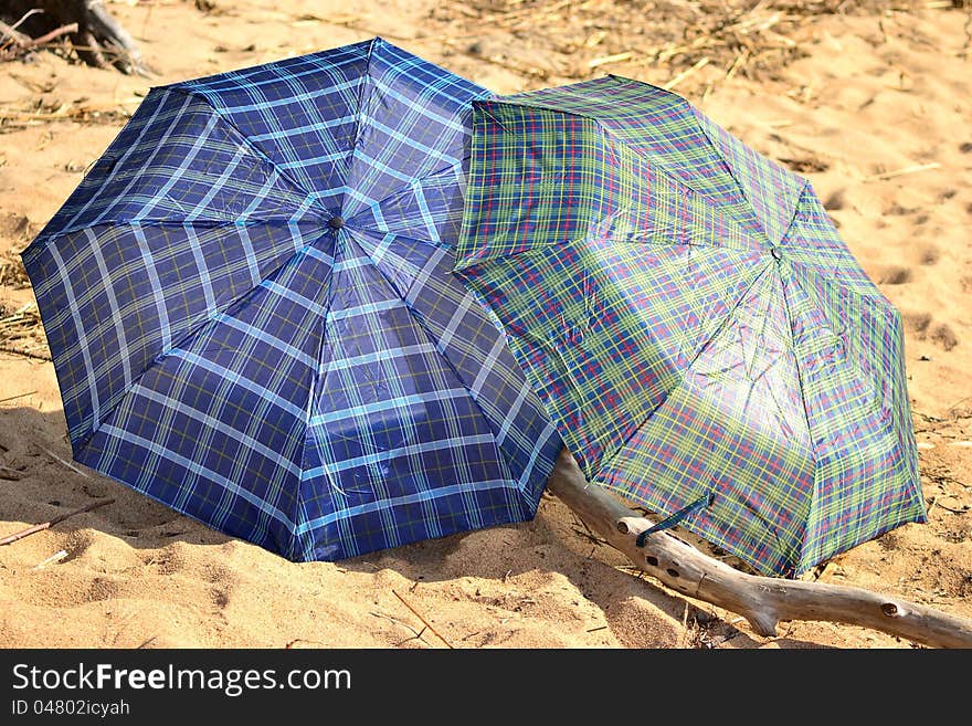 Two umbrellas on the beach in a sunny day. Two umbrellas on the beach in a sunny day