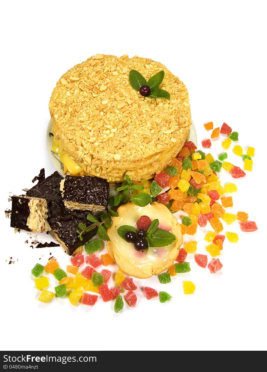 Cake, waffles and candied fruit on a white background