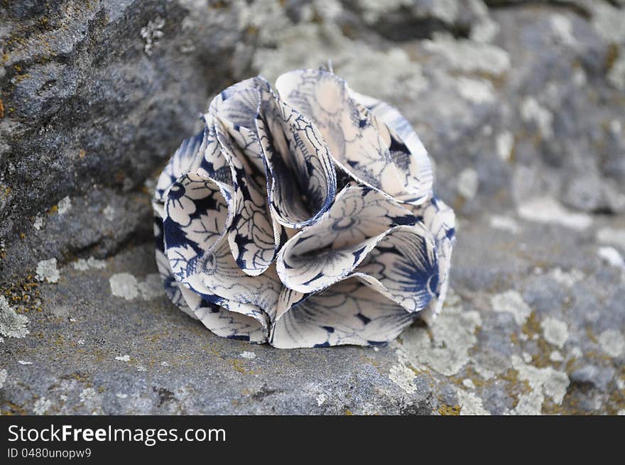 Handmade brooch on stone background.