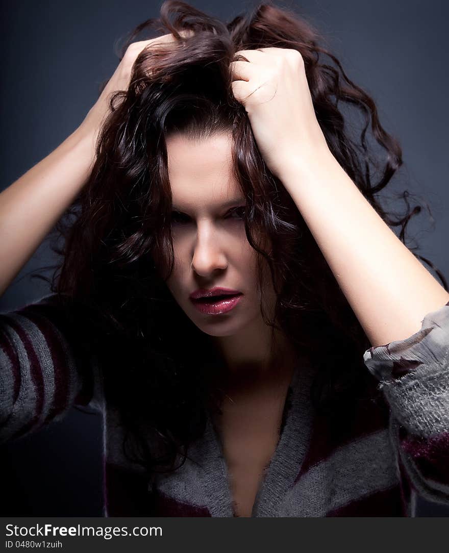 Astounded brunette female stressed is going crazy pulling her brown hair in frustration. Astounded brunette female stressed is going crazy pulling her brown hair in frustration