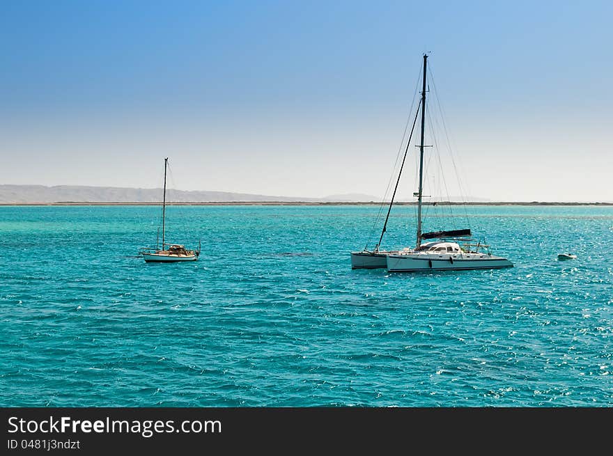 Two boats in azure bay