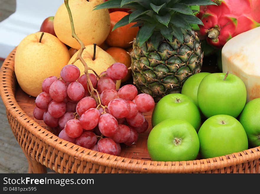 Various fruits on rattan basket.