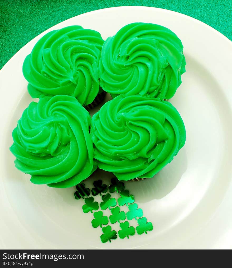 Four cupcakes placed together to shape a shamrock. A festive display for Saint Patricks Day. Four cupcakes placed together to shape a shamrock. A festive display for Saint Patricks Day.