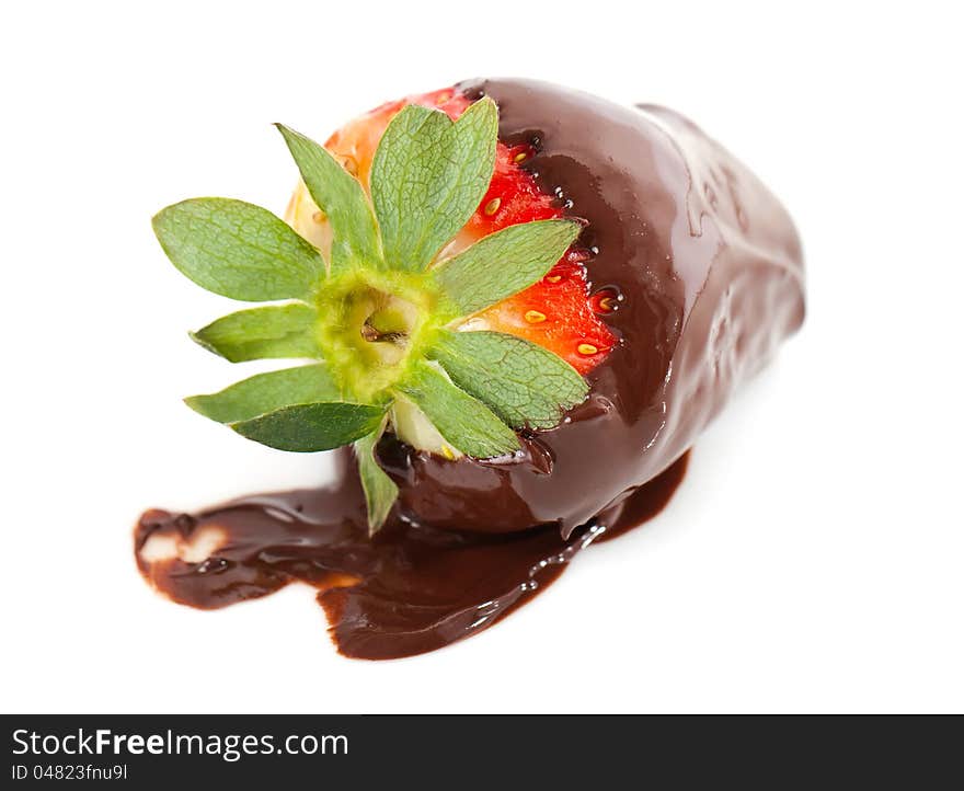 Ripe red strawberry dipped in liquid chocolate coating in a gourmet dessert. Ripe red strawberry dipped in liquid chocolate coating in a gourmet dessert