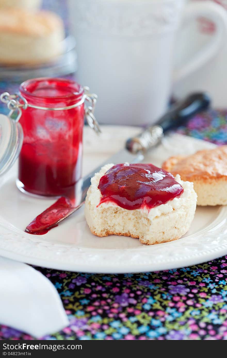 Scone with plum jam, selective focus