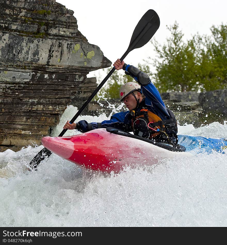 Kayaker in the waterfall in Norway