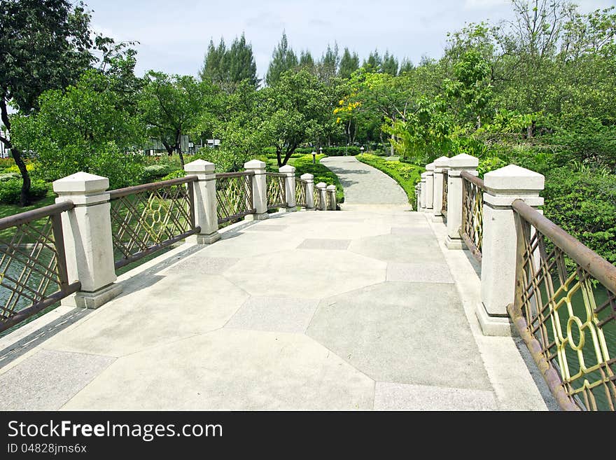 Bridge in the park with green trees. Bridge in the park with green trees.