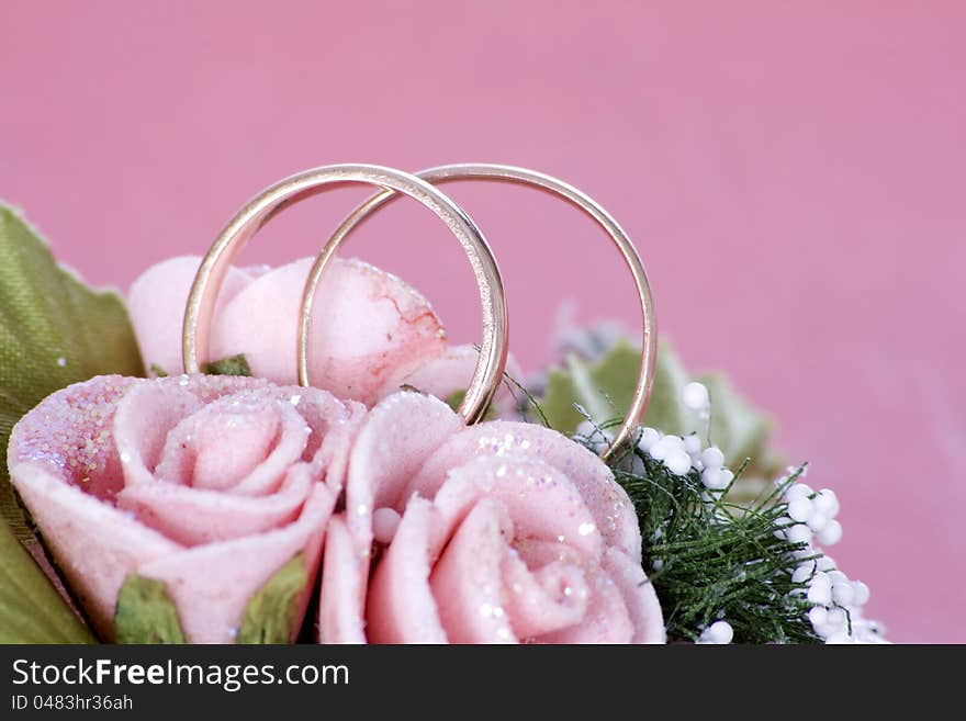 Two Golden Wedding Rings on flowers