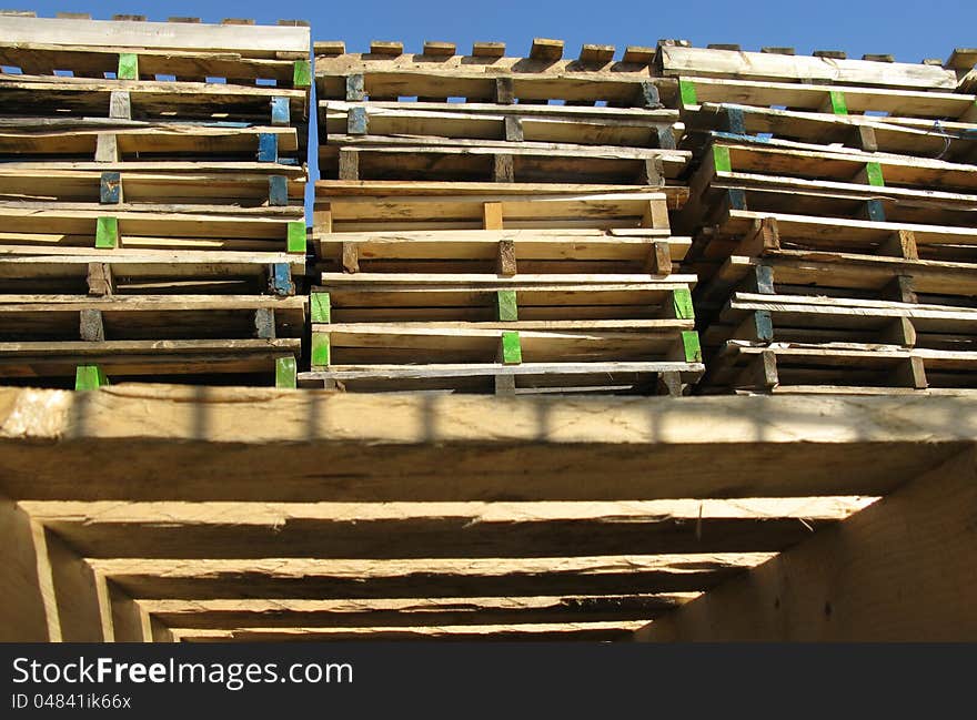 Piles of industrial wooden pallets. Piles of industrial wooden pallets