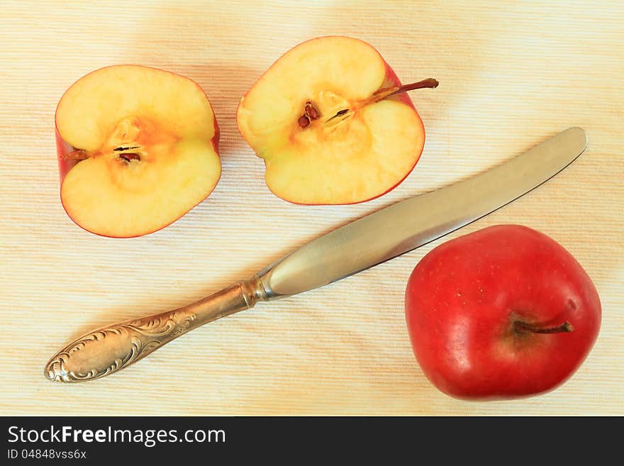 Red apples and knife cut apple