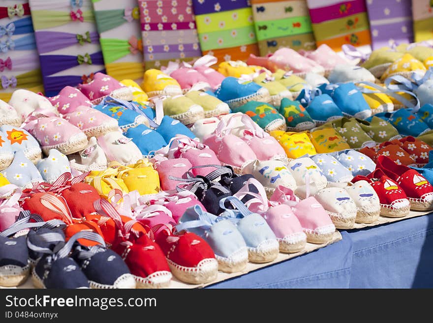 Small cloth sandals in various colors for babies. Small cloth sandals in various colors for babies