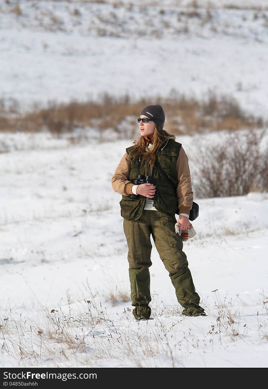 Girl standing on frozen meadow. Girl standing on frozen meadow