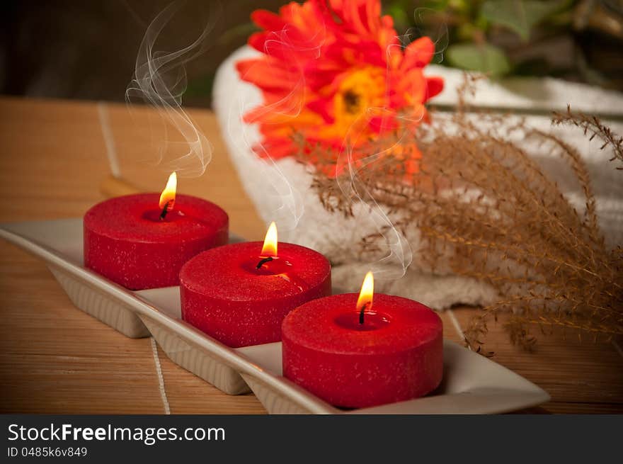 Three scented candles on bamboo mat. Three scented candles on bamboo mat