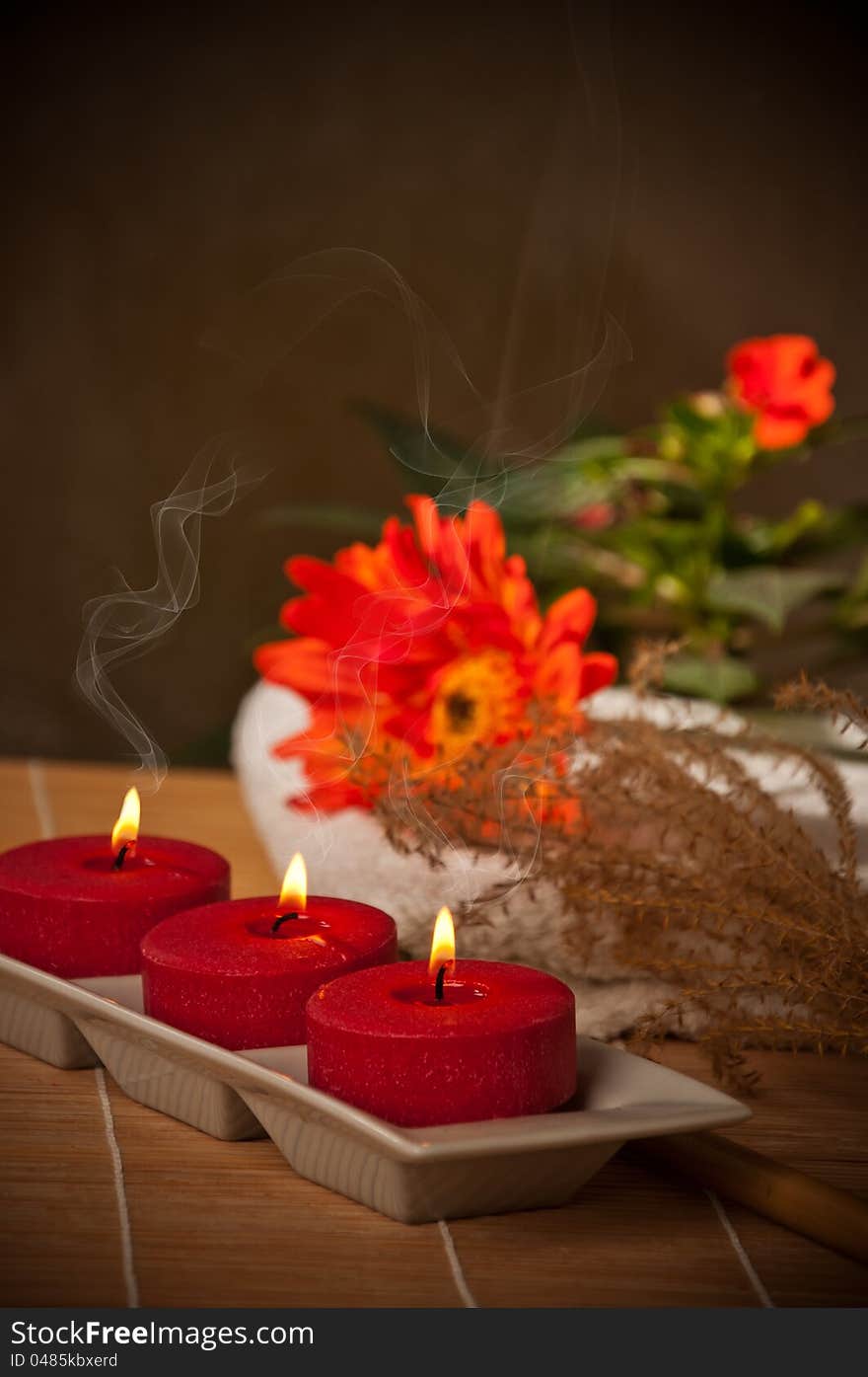 Three scented candles on bamboo mat. Three scented candles on bamboo mat