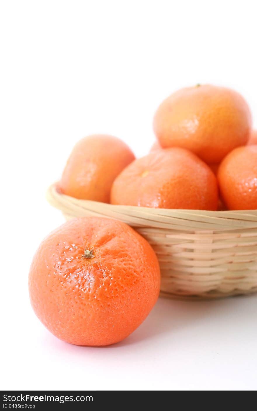 Mandarin in the basket isolated on white background. Mandarin in the basket isolated on white background