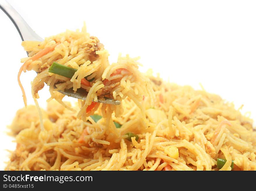 Singapore Style Stir Fried Rice Noodles with curry powder, and pick it up with fork