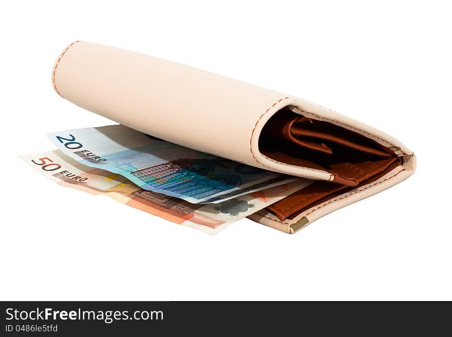 Monetary denominations lie in a wallet on a white background