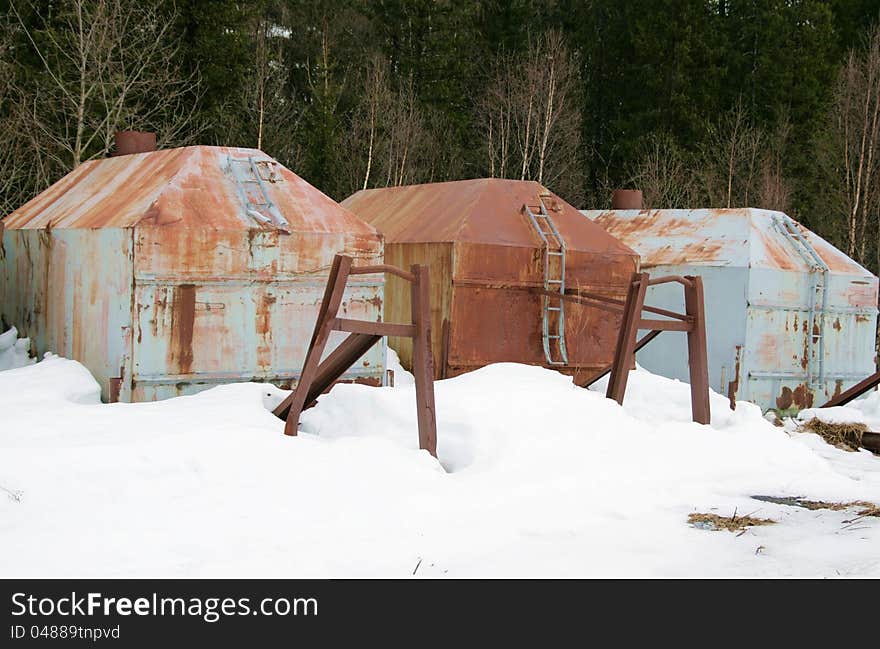 Rusty old containers dumped in a forest