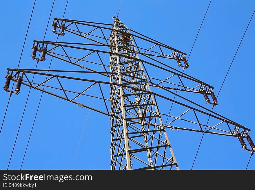 Electricity pylon against blue sky