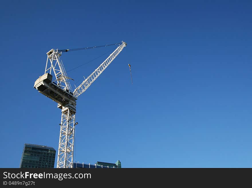 A construction tower cran against blue sky,Toronto,Canada. A construction tower cran against blue sky,Toronto,Canada