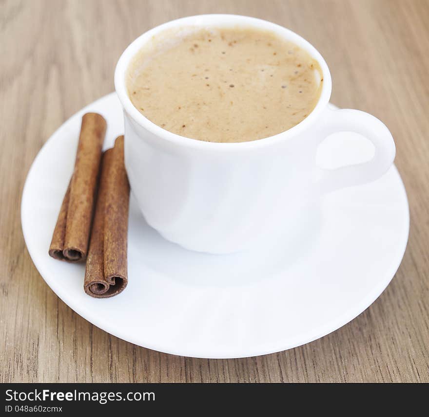 Cup of cappuccino with cinnamon on the table