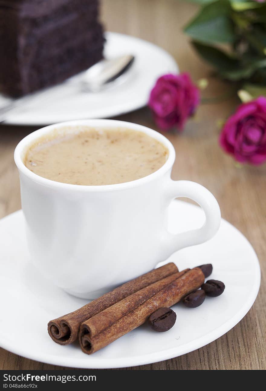 Cup of cappuccino with cinnamon and  coffee beans