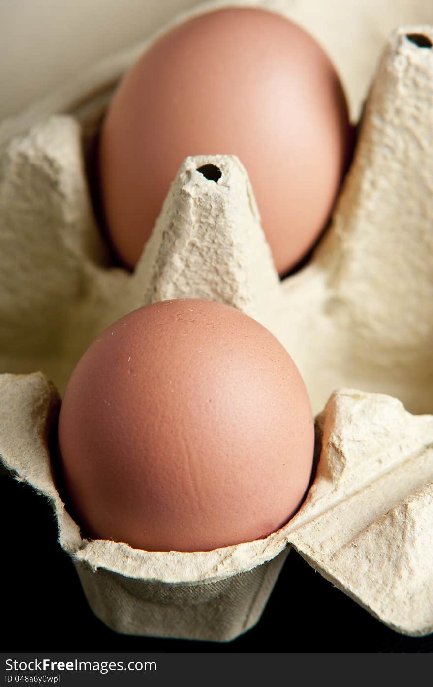 Eggs in a package in black background close up