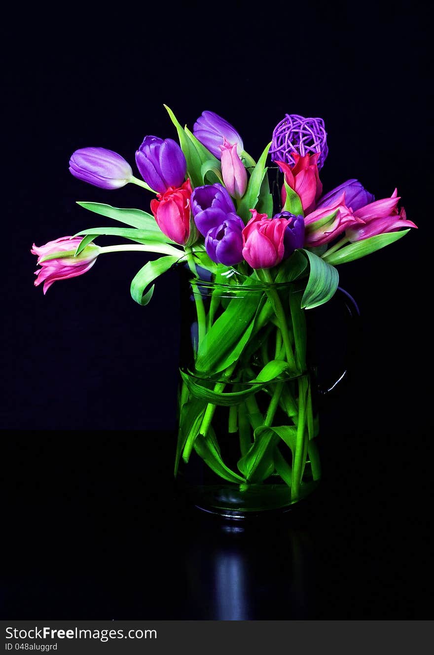 Colorful tulips in green vase. Colorful tulips in green vase