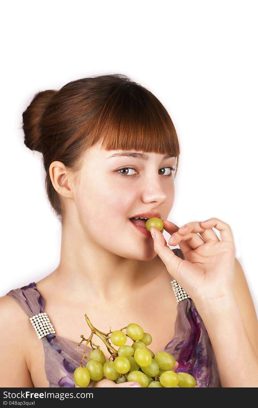 Sensual  pretty girl eating grapes isolated