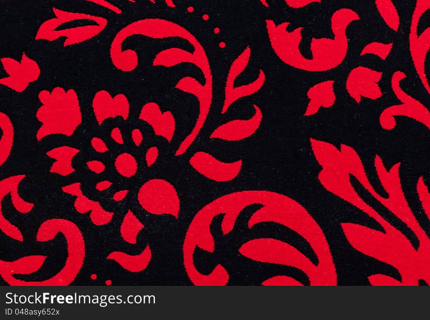 Close-up photo of red-black, mild, patterned carpet. Close-up photo of red-black, mild, patterned carpet