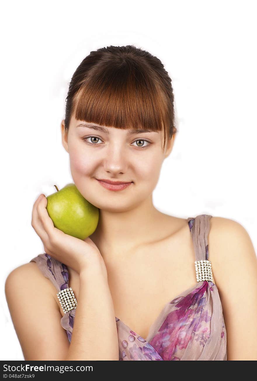 Young happy woman holding an apple on white background