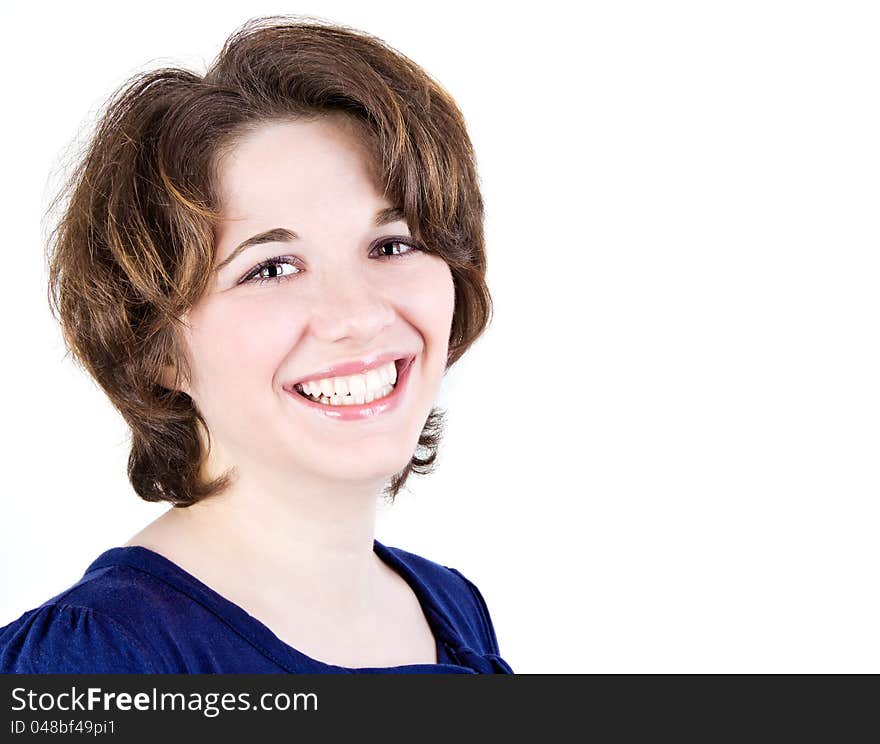 Portrait of the smiling young girl on a white background