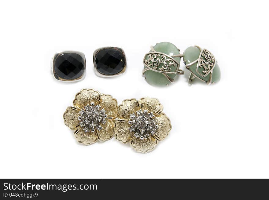 Several pairs of earrings on a white background