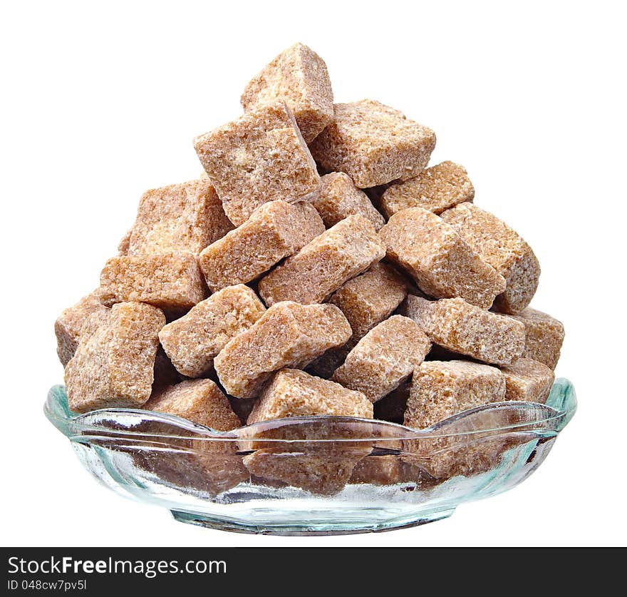 Cane sugar in a glass plate isolated on a white background